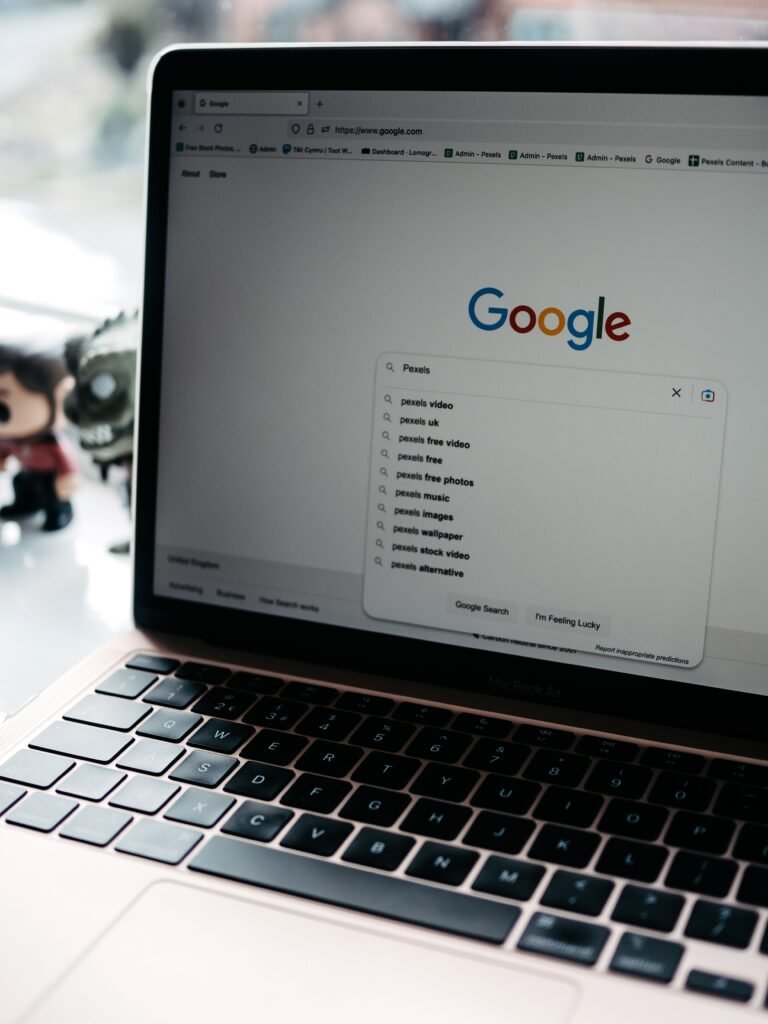 A close-up shot of a laptop displaying a Google search page with related searches visible.